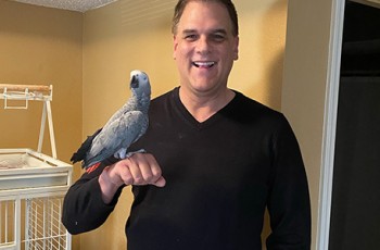 Jeff Wetterman with his Congo African Grey Parrot, Gracie.