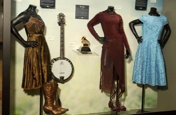 (L-R) Taylor Swift’s dress worn in Tim McGraw’s music video and her banjo played in her 2010 music video “Mean.” Faith Hill’s 2017 Soul2Soul Tour dress and 2002 Grammy award. Miranda Lambert’s dress worn during “Mama’s Broken Heart” 2010 music video.