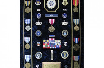 Like many Veterans I have a shadowbox in which I display my medals, ribbons and badges. As you can imagine, I ended up with a rather large collection at the end of my 21 years. I served during the Vietnam War as well as Desert Storm. It’s pretty apparent when you see my shadowbox that I take a lot of pride in that part of my life. Most Veterans do. Prominently displayed at the center of my shadowbox is a Meritorious Service Medal, my highest honor. Seven of my medals are from the Air Force. Two of them are from the state of Georgia, of which one is for the time I spent in the Venue Officer Unit during the 1996 Centennial Olympic Games in Atlanta.