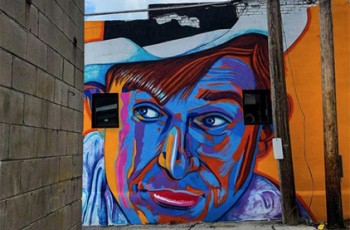 Alley Activation mural of Will Rogers at North Block Common.