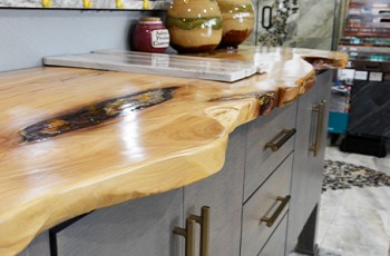 Live age countertops and furnishings are a finished real wood, giving a beautifully natural aesthetic to the kitchen or bath.  Inlays with natural fibers can also be included, such as stones or seashells.