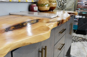 Live age countertops and furnishings are a finished real wood, giving a beautifully natural aesthetic to the kitchen or bath.  Inlays with natural fibers can also be included, such as stones or seashells.