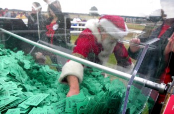 Mr. Claus himself draws the winning Santa Cash ticket.