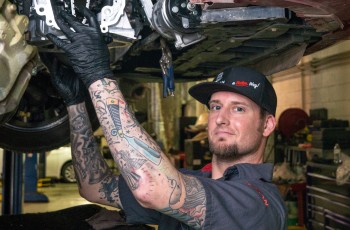 Shop foreman Chris Sheets working on a Nissan Sentra.