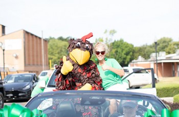 Rosco the Rooster and Rosie Kramer, Community Relations Partner for TTCU Federal Credit Union.