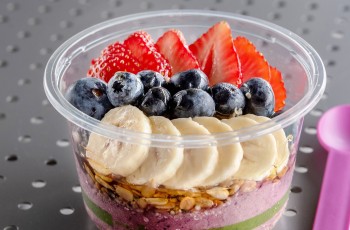 The Red White & Blue bowl is a berry blend topped with strawberries, banana, blueberries, chia seeds, hemp hearts, granola and raw local honey.