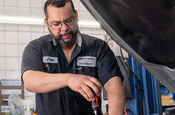 Service technician Jorge Quintanilla replaces an engine air filter.