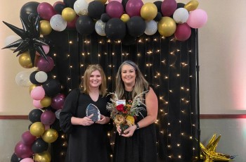 2021 Leader in Education Christi Mackey of Rogers State University and Sara Moss, presenting the award on behalf of Robson Properties.