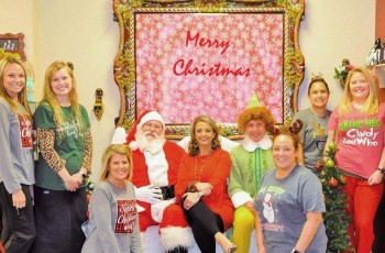 Dr. Fowler and staff got into the spirit of Christmas last December at their holiday, with a little help from Santa Claus and Buddy the Elf. Yuletide celebrants at Advanced Vision Center included Robi Gayman (from left), Kristi Tipton, Lora Walker, Santa Claus, Dr. Fowler, Buddy the Elf, Holly Patton, Alicia Johnson, and Casey Murphy.