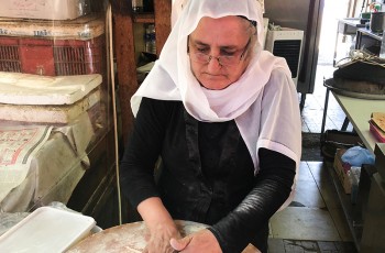 Fresh dough for pita bread being prepared by hand.