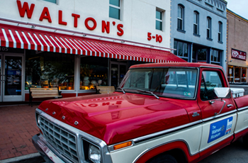 Red and White pickup truck that belonged to Sam Walton, founder of Walmart parked in front of his first five and dime store, now the Walmart Museum in Bentonville, Arkansas.