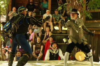 A duel between professional fencers entertain the crowds.