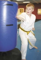 Ten-year old Michael Capps demonstrates the knife hand strike during a class at Martial Arts Advantage.