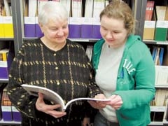 RCLC tutors Patti Glaze (left) and ­Jennifer Curtin discuss the adult learner resources at the literacy office. Age is not a factor when it comes to volunteering, as these two represent opposite ends of the spectrum. Glaze is 82 years old, and Curtin is 28.