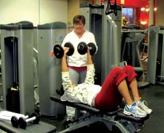 Personal trainer and fitness class instructor Tami Rice works with a client at Fitness Time for Ladies.