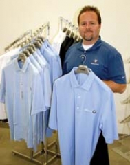 Parts Manager Steve Morris with samples of ­monogrammed BMW shirts.