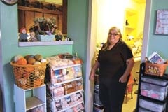 Owner Carolyn Dormier shows a small sample of the large ­selection of yarn that is available for purchase at Country Grannie’s Play House in Inola.