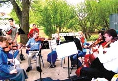 Middle school aged children performing outdoors.