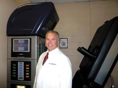 Dr. Craig Day stands in front of the DRX9000.