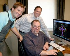 J. David Jewelry owner Joel Wiland (back) with 
jewelry designer Frank Tremonti (seated) and master jeweler Nathan Wynn (left) overlooking a computer-aided custom pendant design.