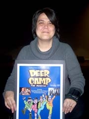 Ruby Quinn, executive director of Robson Performing Arts Center, holds the poster for “Deer Camp: The Musical!”.