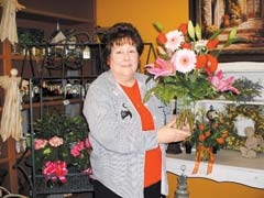 Owner Sheri McLaughlin holds an example of Art in Bloom’s Valentine’s Day bouquets.