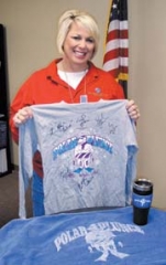 Event organizer Lisa Ford shows off a Polar Plunge T-Shirt and other items that will be presented to award winners.