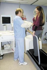 Paul Knell, RN, OSUMC CV Specialist, explains how to use the new treadmill to a patient.