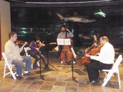 The strings section will perform in the shark exhibit at Oklahoma Aquarium’s Symphony by the Sea for Students.