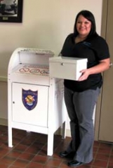 Holding one of the free prescription lock boxes, Amber ­Brassfield with the Claremore Police Department is also on the Rogers County Drug Force, which encourages citizens to be responsible with their prescription drugs.