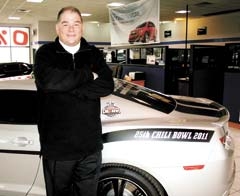 Suburban Chevrolet General Manager Tim Kirk with the Camaro Pace Car commemorating the Chili Bowl’s silver anniversary.