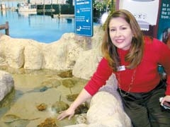 Oklahoma Aquarium’s Executive Director Teri Bowers coaxes inhabitants in the Reasor’s Shrimp Boat exhibit.