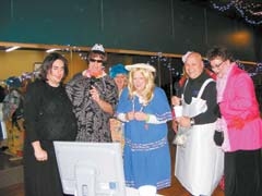 (L to R): Joe Perez, City of Claremore, Cole Butler, Tulsa Police Department, Nan Pope, City of Claremore, Scott Walton, Rogers County Sheriff, and Mike Helm, Rogers County Commissioner, sing karaoke at last year’s “Old Bag” Dinner &amp; Auction, benefitting Safenet Services.