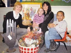 Denise Frihart, Lisa Adams, committee chair, and helpers with auction items for the 16th annual Happy Hands Silent Auction and Dinner.