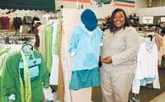 Tina Sweet shows off the spring ­
collection at a Goodwill store.