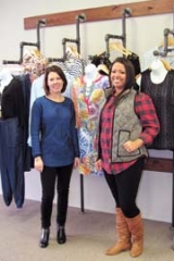 Owner Cari Bohannan, left, and sales associate Hillary Blaine are excited about one of the bright new looks for spring at The 
District on Main. New merchandise and new lines are arriving daily at the upscale boutique located in downtown Claremore.