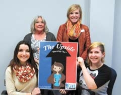 Seated from left, NTC EAST program students Rheanna Martin and Kayla Salle display the cover of their comic book “The Upside: Burning Out” designed to educate Rogers County teens about the dangers of smoking. Standing behind the girls are Amy Graham and Alyson Short with Volunteers for Youth.