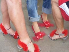 Some male participants sported red high heels as they walked in last year’s Walk a Mile in Her Shoes sponsored by Safenet Services.