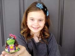 Erin holds a turtle she adopted and decorated.