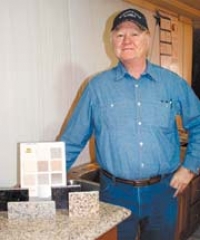 Owner Rex Marsh with some of the new granite 
and manmade Harmony Stone materials and 
colors available from Harmony Star Marble.