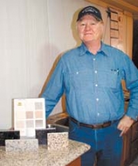 Owner Rex Marsh with some of the new granite 
and manmade Harmony Stone materials and 
colors available from Harmony Star Marble.