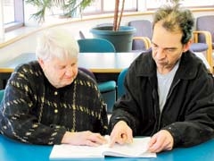 Rogers County Literacy Council tutor Patti Glaze works with her adult learner Chuck DeHart in the Will Rogers Library. Glaze and DeHart meet once a week for an hour to help him meet his goal of improving his reading skills.