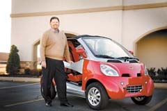 Jack Rodden, president of Mill Creek Carpet and Tile, and the electric car the company is giving away in their Triple Green Giveaway.