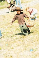 A child gathers Easter eggs at last year’s Easter Egg Hunt.