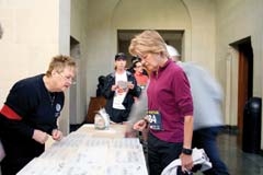 Longtime runner Jeannie Seidel of Claremore, one of the ­ultimate runners in the Wings’ Will Rogers Memorial 5K Run, signs in with Sherry Whisler, Will Rogers Memorial ­Museums Roper (docent), at last year’s event. She placed first in the 55-59 age group. Seidel’s grandson, Kort, 8, ran the 1K Fun Run, his first-ever run. Her daughter-in-law, Nikki, ran in the 5K. Seidel teaches physical education and health at Claremore’s Catalayah Elementary and has started a running club, which has grown to more than a hundred students. Some of them will likely be in the Will Rogers ­Memorial Race.