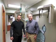 Dr. Voto (left) and Dr. Drake beside the digital X-ray machine.