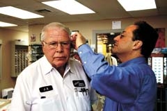Optician George Dakil adjusts glasses for longtime customer J.R Asher, owner of Asher’s Commercial Refrigeration.