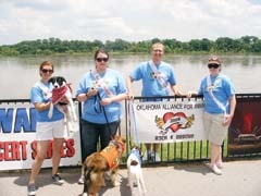 OAA’s annual Rock and Rescue pet festival takes place May 22 at RiverWalk Crossing in Jenks. (L to R): Kristin McElyea, Julie McElyea, Jason McElyea and Jenny McElyea with dogs from the Tulsa Animal Shelter.