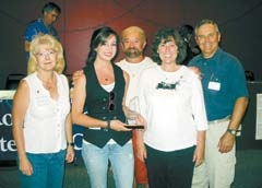 The Rogers County Literacy Council Spelling Bee champion team 2009 was a family effort. Literacy Council Executive Director Carol Round (left) and Council President Mike Gardner (right) congratulate Hayley Holmes (center from left) and her parents Randy and Marla with last year’s “To Bee or Not To Bee” spelling trophy. The spelling bee event raised nearly $2,000 for literacy programs in Rogers County.