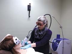 Taryn Schell performs a laser hair removal treatment on Kelley Tompkins, using the Candela GentleLASE laser.